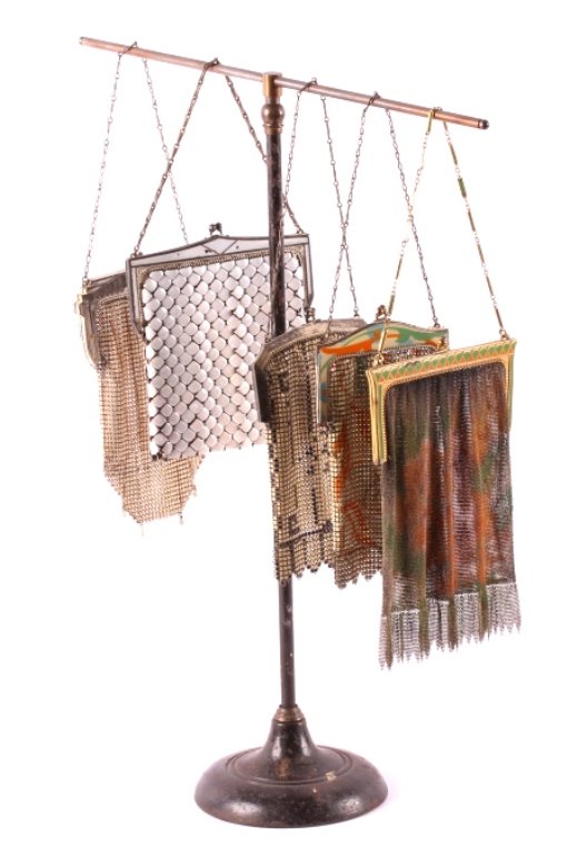 Antique Ladies Mesh Purse Collection: This is a collection of five ladies mesh purses. Each purse is marked "Whiting & Davis Mesh Bags". They all show a beautifully painted enamel design. The stand for the purses is included with this lot
