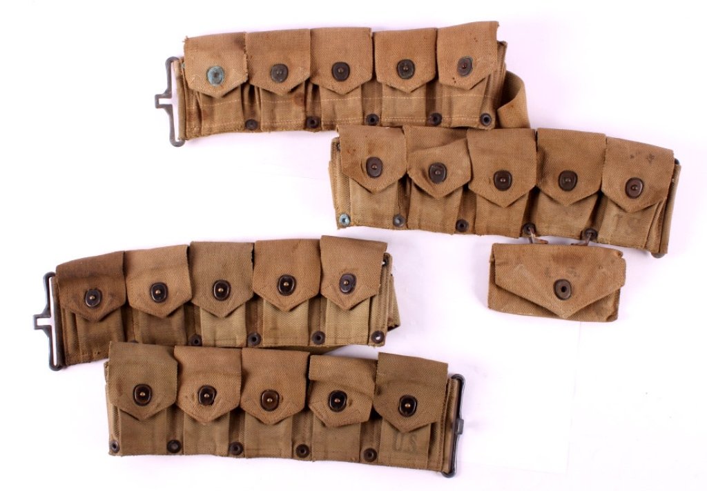 WWII M1 Garand Ammunition Belts: This is a pair of M1 Garand ammunition belts from WWII. Each belt has 10 pouches. One belt has an additional pouch for a field dressing. One of the belts is marked "Boyt 43". The other belt is not mar
