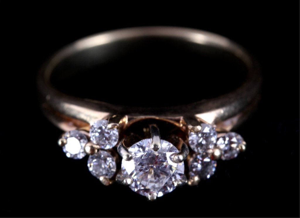 1.1ct Diamond & 10k Yellow Gold Ring: The ring features 1.1ct of beautiful bright diamonds on a 10k yellow gold ring setting. The ring has seven round brilliant cut diamonds with the center stone being .5ct and the side stones being .1ct