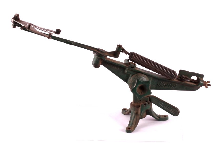 Cast Iron Winchester Western Clay Pigeon Thrower: This is a cast iron clay pigeon thrower. The thrower is marked "Western Arms and Ammunition Division". It has a base that has a directional adjustment. In addition, there is an adjustment for elevatio