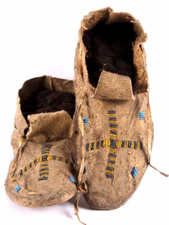 Northern Plains Beaded Moccasins Otto Ernst 1890: This is a set of Crow Native American beaded moccasins from the Otto Ernst Collection. The moccasins are beaded across the tops with a cross design surrounded by four box motifs. The set is from circa