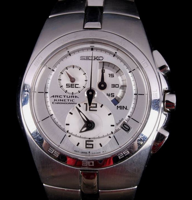 Seiko Arctura Kinetic Chronograph Men's Wristwatch: The watch features a stainless steel bezel and band with sapphire crystal. The piece is a Seiko Arctura Kinetic Chronograph men's wrist watch. This appears to be in good working order with minimal wea