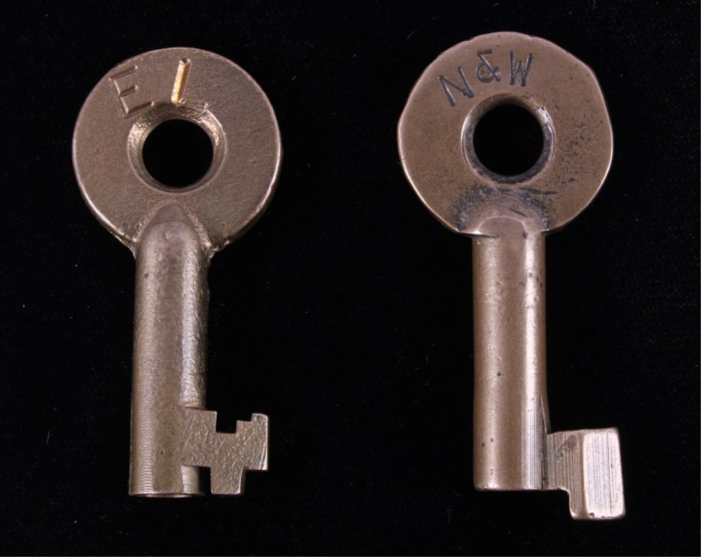 Norfolk Western & Erie Lackawanna Adlake Lock Keys: The lot features two original mid to early 1900 brass switch lock or padlock keys made by Adlake for the Norfolk & Western Railroad and the Erie Lackawanna Railroad. The first key is marked "N&W" and