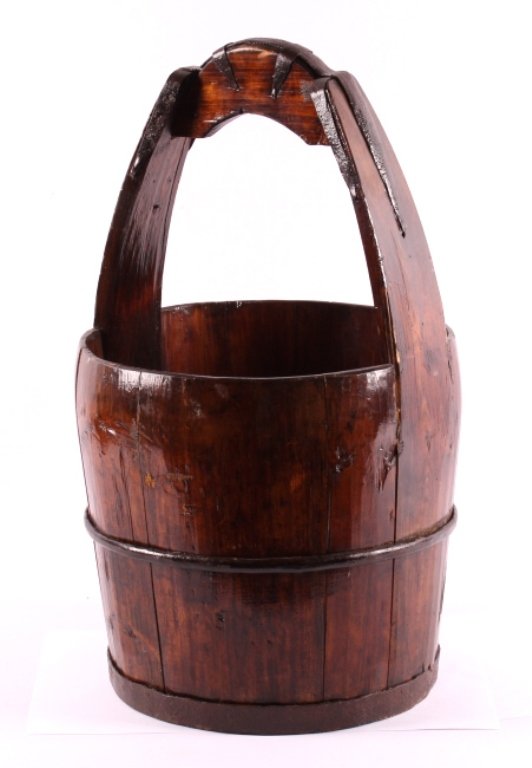 Antique Wooden Well Bucket: This is an antique wooden well bucket. The bucket is made from solid wood with hand forged iron strapping. The bucket shows good condition. A great primitive decor piece. The antique bucket measures 1
