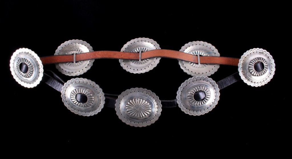 Navajo Second Phase Silver Conch Belt c. 1900-1930: The piece features a early and rare Navajo Native American Indian Second Phase (2nd Phase) concho silver belt. The belt features all hand tooled silver large conchos on a black leather belt. The belt