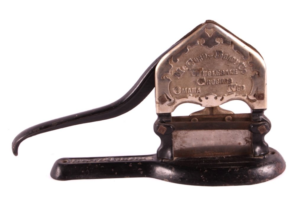 Antique Tobacco Cutter from Omaha Nebraska: This is an antique tobacco cutter. The cutter is marked "McCord-Brady Co. Wholesale Grocers Omaha, Neb.". It is also marked "Patented Dec. 1, 1914". Thomas Johnson successfully patented this tobacco c