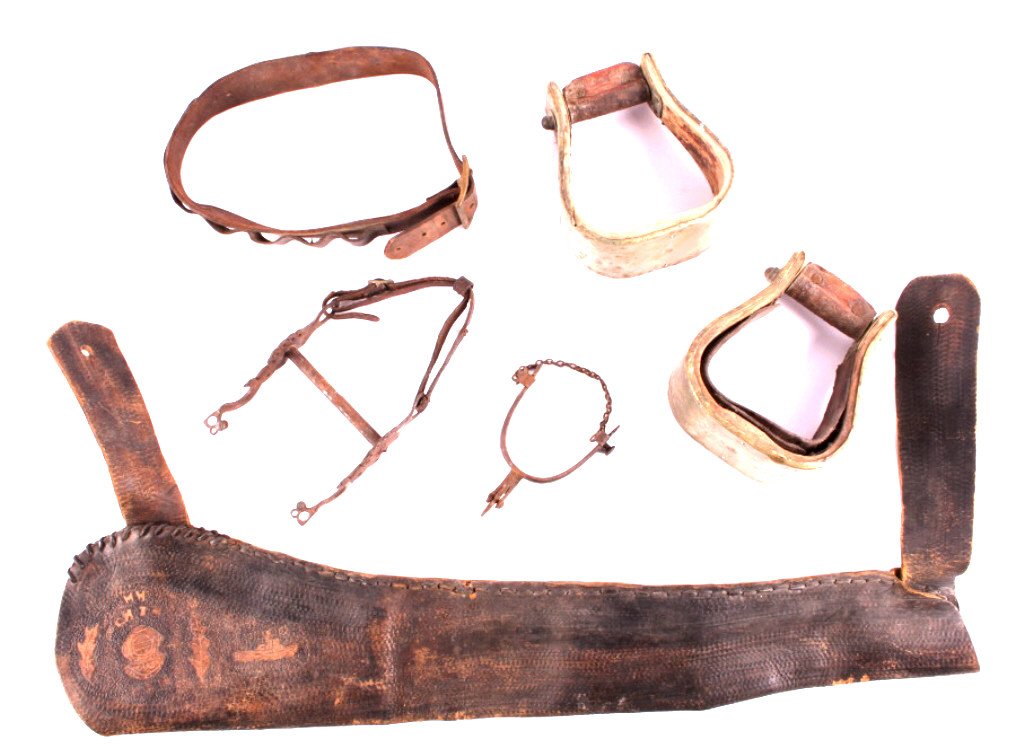 Western Leather and Tack Collection: This is a Western leather and tack collection. The collection includes a silver mounted horse bit, a single August Buermann spur, a tooled leather gun scabbard with trench art, and bentwood stirrups.