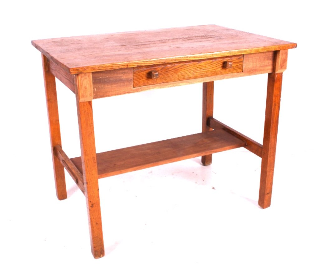 Antique Oak Library Table: This is an antique oak library table. The table is made form solid oak. It features a pull out writing desk. The writing desk is made from oak also and has an ink well with an ink bottle. The antique 