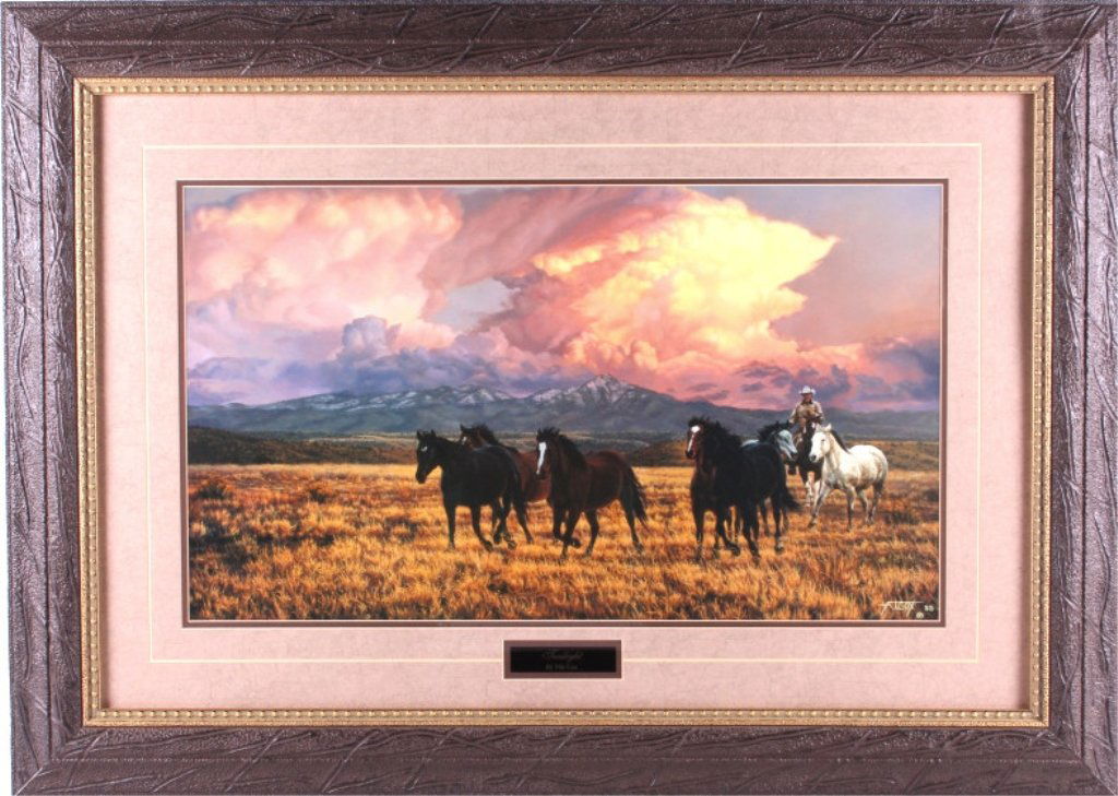 Tim Cox Framed Western Print: This is a framed Western print by Tim Cox. It is titled "Twilight" and shows a cowboy driving several horses. ox has been a member of the Cowboy Artists of America since 2007. His paintings portray a