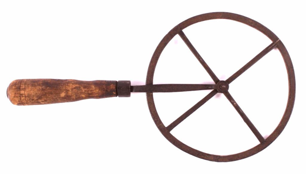 Antique Blacksmith Travelers Wheel: This is an antique blacksmith travelers wheel. This tool was used for making wagon wheels. This piece shows hand forged construction with a wooden handle. It is in good condition. It measures 7.5" in