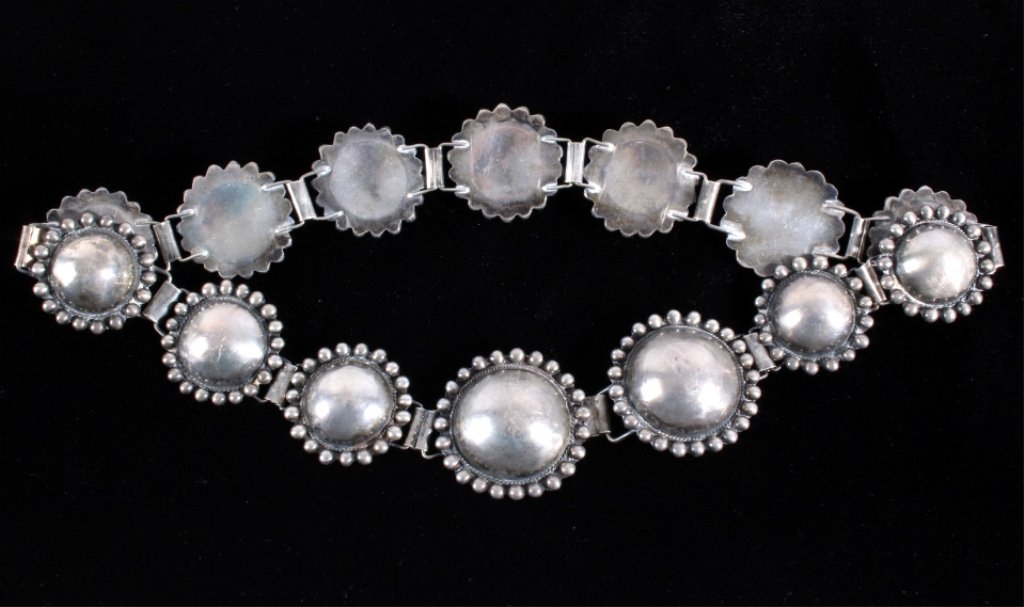 Antique Navajo Silver Concho Belt: This is a Navajo Native American sterling silver concho belt with a unique desirable design. The belt shows two larger conchos in the center with 12 smaller conchos. Each conchos have round silver acc
