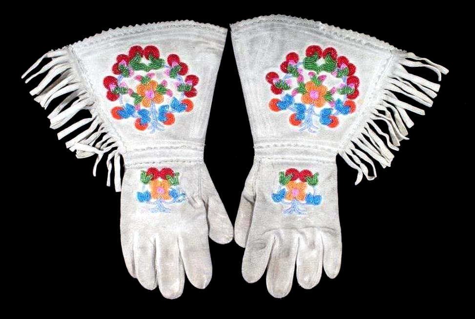 Northern Plains Indian Beaded Gauntlet Gloves: The set features Indian tanned hide with glass trade beaded floral design from the Northern Plains Native American Indians. The set are in good condition with little to no bead loss. The gloves also h