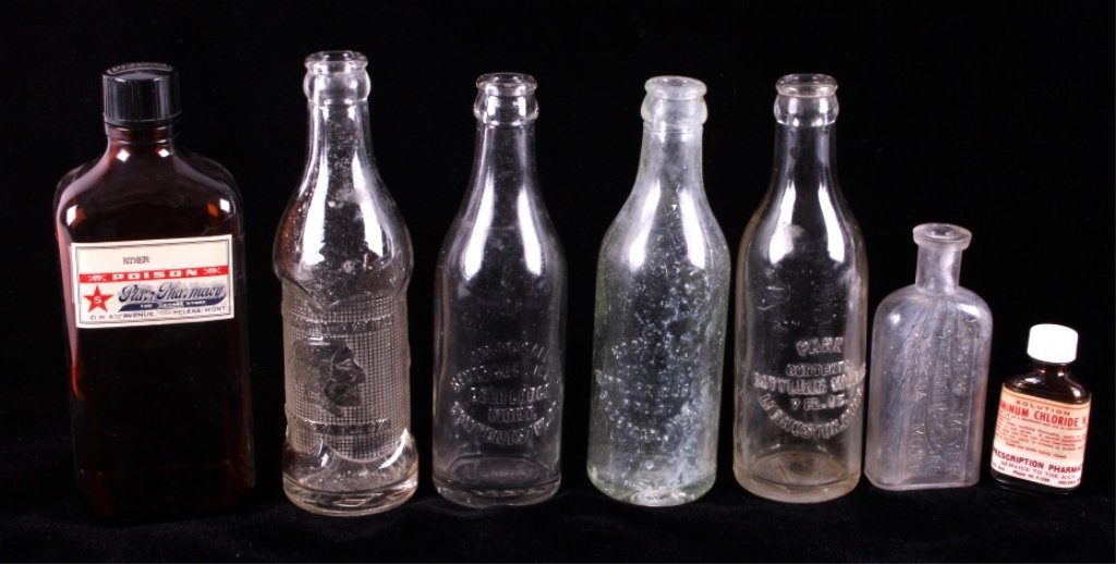 Montana Soda and Pharmacy Bottle Collection: This is a collection of seven soda and pharmacy bottles from Montana. Included in this collection is a poison bottle from Starz Pharmacy Helena, Mont., an aluminum chloride bottle from Prescription Ph