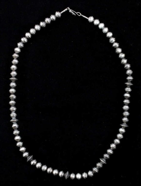 Navajo Sterling Silver Pearl Saucer Bead Necklace: This is an Old Pawn sterling silver necklace showing tooled pearl saucer beads on a wire necklace. The piece is a Navajo Native American necklace and shows good condition. The piece shows excellent de