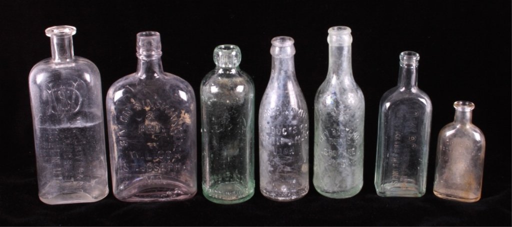 Antique Bottle Collection: This is a collection of seven antique bottles. Included is a Thomas Edison battery oil bottle, Wm. Driver & Son Druggists Ogden Utah (crack on base/side), Dr. Caldwell's bottle, City Bottling Works Sp