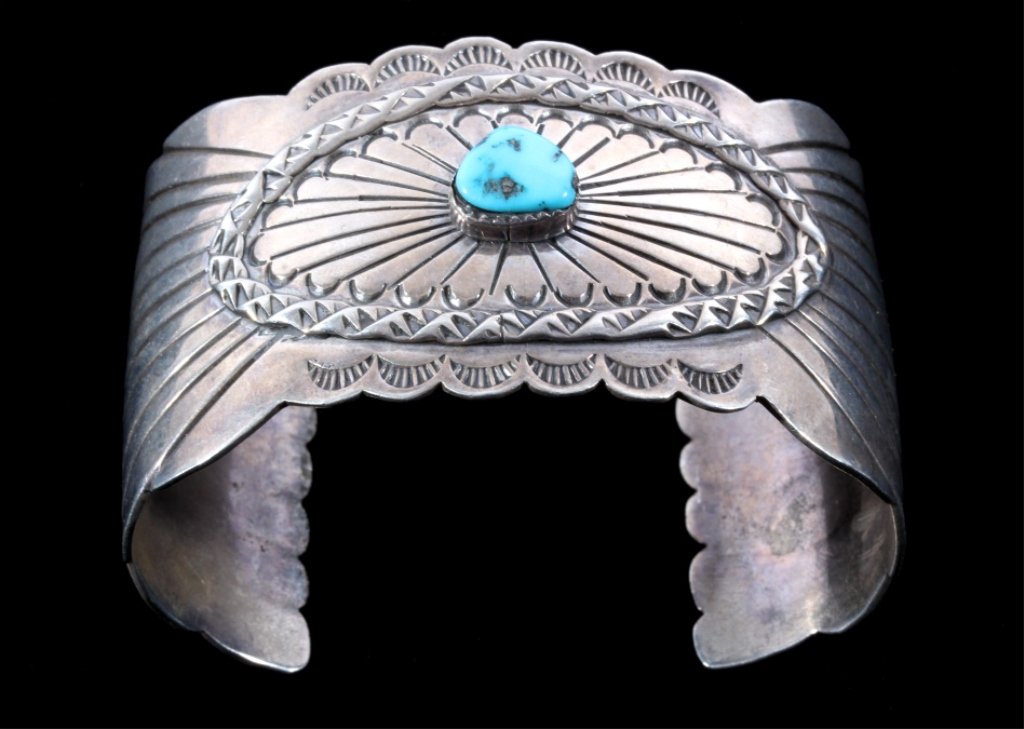 Navajo Old Pawn Sterling Turquoise Large Bracelet: The piece is a mid to early 1900's Navajo Native American Indian old pawn sterling silver heavy worked cuff or bracelet with a beautiful center turquoise stone. The piece is hallmarked, "G. Wade" and 