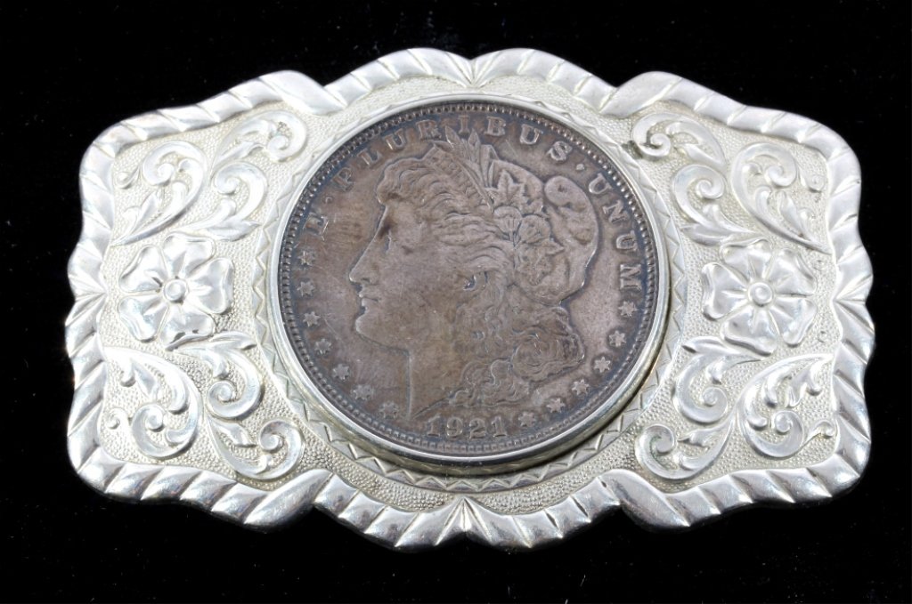 Navajo 1921 Morgan Silver Dollar Belt Buckle: This is a nickel silver floral belt buckle with a 1921 Morgan Silver Dollar in the center. The coin and buckle are in good condition (coin has a deep patina). Measures 2 1/8"x3.25".