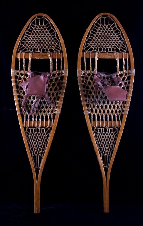 Antique Maine's Best Wooden Snowshoes: This is a pair of antique wooden snowshoes. They are marked "Maine's Best". The snowshoes feature rawhide lacing with leather bindings. The snowshoes are in good condition. Great Western or cabin deco