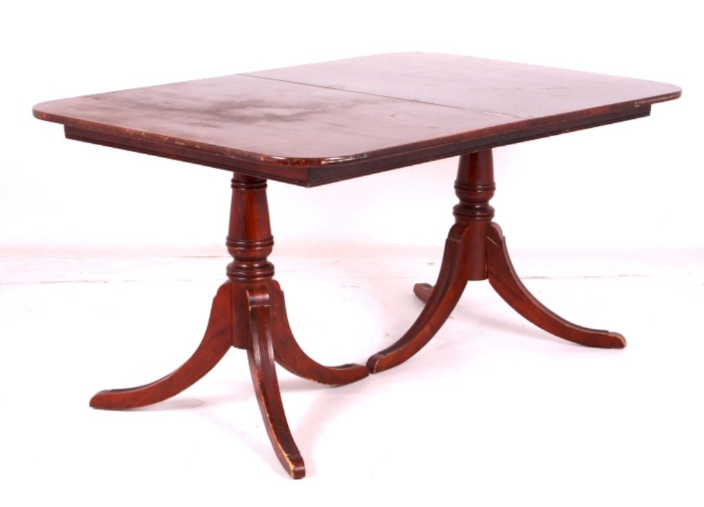 Duncan Phyfe Mahogany Dining Room Table: This is a Duncan Phyfe dining room table. The table is made from mahogany and features two pedestals with three legs each. The table shows good overall condition. It measures 40" x 60" and is 29" tall
