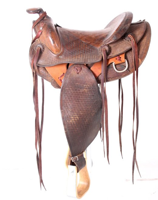 Early Vintage Basket Weave Tooled Saddle: This is a hand crafted Western tooled saddle with a basket weave design. The saddle is in good condition showing signs of use. The piece is not marked. This has solid nickel rings. Saddle has a 12" se