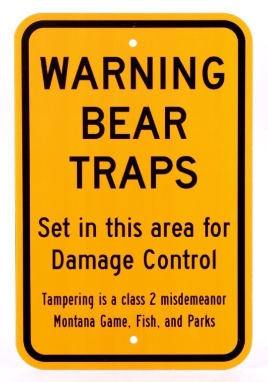 Montana Game Fish, & Parks Bear Trap Sign: This lot features a bear trap sign. This sign was used to designate an area that had bear traps set. The sign was utilized by the Montana Game, Fish, and Parks to warn people that traps were set in th