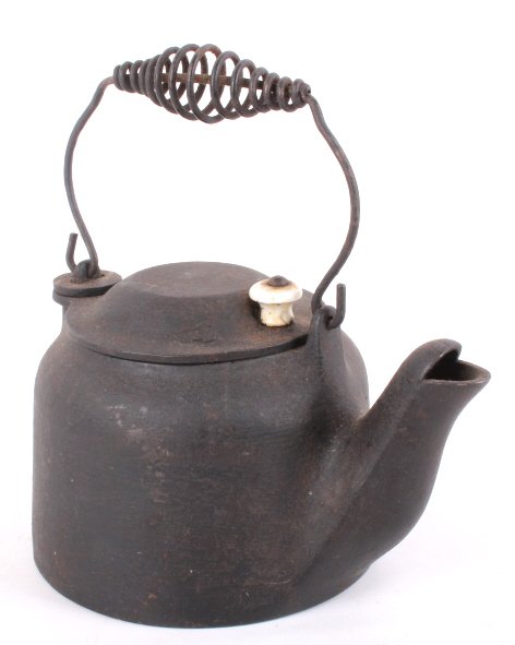 Wagner Ware Cast Iron Toy Tea Kettle: This item is a Wagner Ware toy tea kettle. This is referred to as a toy or small kettle, kettle has swivel lid with porcelain like knob and coil handle. The bottom is marked "Wagner Ware Sidney -O- B"