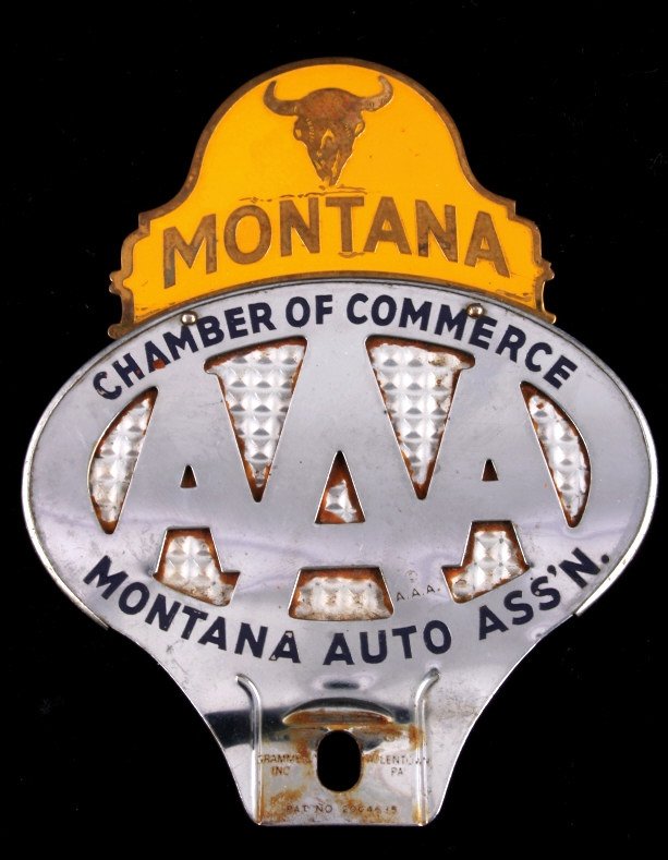 Montana AAA License Plate Topper: This is a Montana AAA license plate topper. The topper shows the AAA logo and reads "Chamber of Commerce Montana Auto Ass'n.". The top has an additional tab with a buffalo skull that reads "Montana". 
