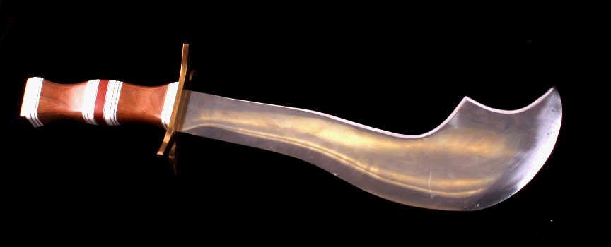 Early Large Custom Made Store Display Knife: This is a large custom made store display knife. The knife has a thick heavy blade. The knife shows a curved stainless steel blade with a brass hilt. The handle is made from wood and a mother of pearl