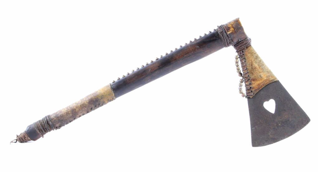 Crow Indian Tomahawk Heart Cutout 19th Century: This is a Crow Native American Indian Tomahawk from the 19th century. The piece shows a brass covered iron tacked oak haft showing a Indian tanned hide wrap having a yellow ocher dye. The piece has an