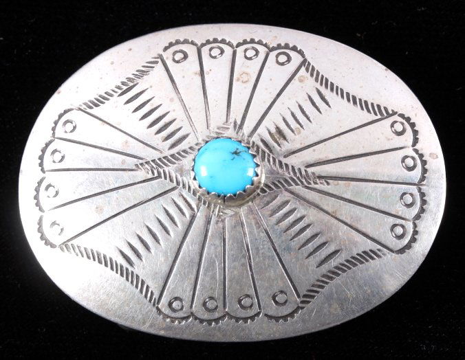 Navajo Sterling Silver Turquoise Concho Buckle: This is a Navajo sterling silver and turquoise concho belt buckle. The buckle features a beautifully hand tooled design with a gorgeous turquoise stone set in the center. The back of the buckle is mar