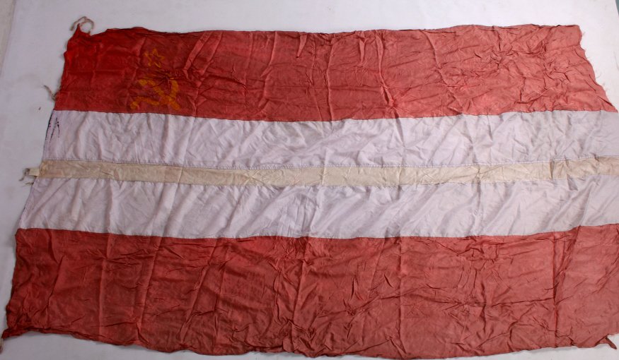 Cold War Russian USSR Swedish Battleship Flag: This is a Cold War era Russian USSR battleship flag from Sweden. The flag shows the hammer and sickle of the USSR with stripes that run through the middle. The flag is in fair condition. It measures 5
