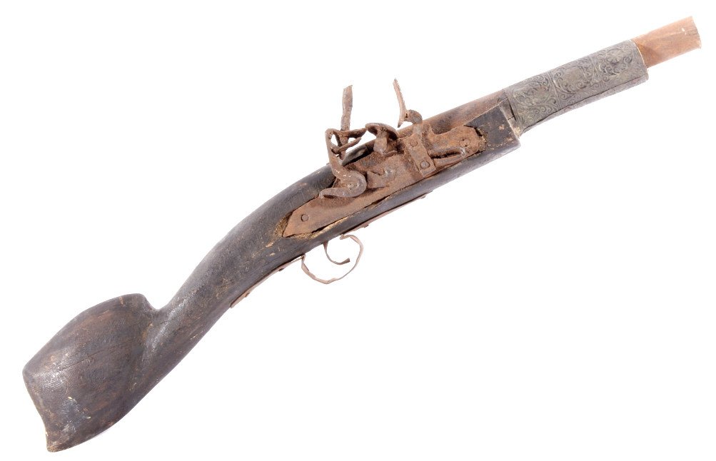 Middle Eastern Flintlock Camel Rifle Blunderbuss: The lot features an antique Middle Eastern Camel Flintlock Rifle. The decorative flintlock shows a short wood stock with pressed copper accent on forestock. The rifle has a caliber of .88 and would ha