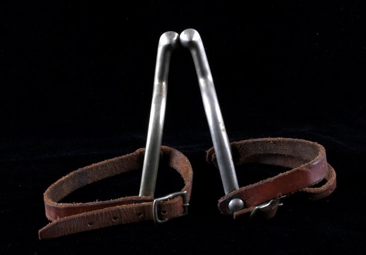 U.S. Cavalry Buermann Marked Spurs: This is a pair of U.S. Cavalry spurs. The spurs were made by August Buermann and are marked "U.S. A.B.". Each of the spurs has a leather strap and shows good condition. The spurs measure 4" x 5.25".
