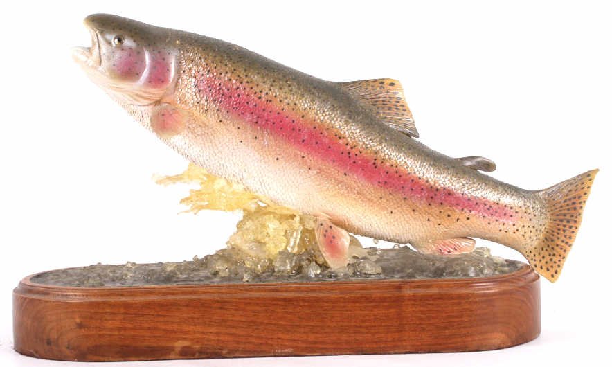 Hand Carved Rainbow Trout Jumping by M. Scott: This lot features a hand carved rainbow trout, mid jump, by Michael Scott. The statue was hand carved and hand painted by artists Michael Scott. The statue's elegant detail depicts one of Americas mos