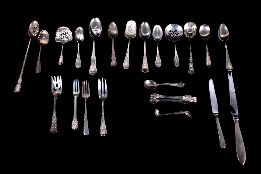 Assorted Sterling Silver Silverware: This lot features an antique collection of assorted sterling silver silverware. The collection includes 14 spoons many of which have elegant designs. Two knives, both of which have sterling handles bu