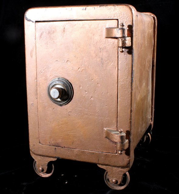 Vintage Personal Safe Cast Iron: This lot features early vintage personal rolling safe. This safe has cast iron wheels, a dial lock, and wood lined interior. Safe is in working order and the code is on hand. L 3-10, R 2-31, L 1-28. S