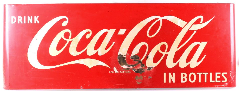 1954 Coca Cola Sleigh Advertising Sign: This is a 1954 Coca Cola sleigh advertising sign. The sign features the stylized Coca Cola logo that reads "Drink Coca Cola in Bottles". The sign has rounded edges and shows the iconic Coca Cola red c