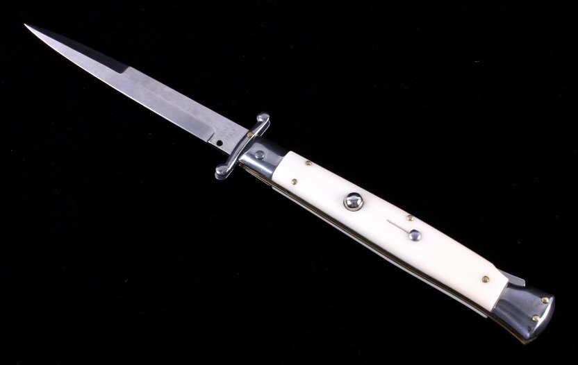 Frank B Italian Switchblade Knife: This is a Frank B Italian switchblade knife. The knife is marked "Frank B Italy" and features an ivory toned celluloid handle. The knife shows very good condition. It measures 11" with a 4.5" blade.