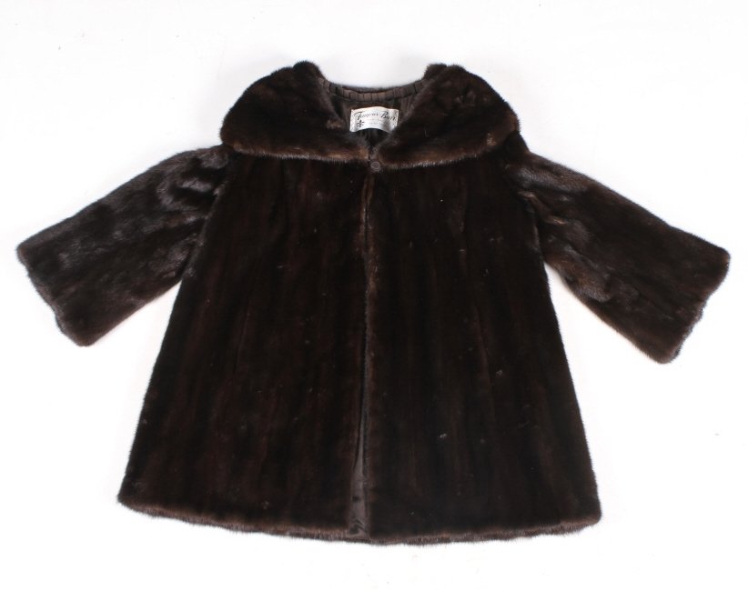 Famous Barr Fur Salon Real Fur Coat: This lot features a minks fur coat by the Famous- Barr Fur Salon in St. Louis. This coat is made of real fur possibly minks. The Famous-Barr Co. or originally the Famous and Barr Co. was a division of