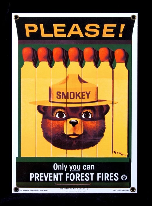 Smokey Bear U.S. Forest Service Porcelain Sign: This is a Smokey Bear porcelain enamel sign. Smokey Bear was adopted by the U.S. Forest Service back in the 1940's as part of their campaign to prevent forest fires. This sign shows a book of matches