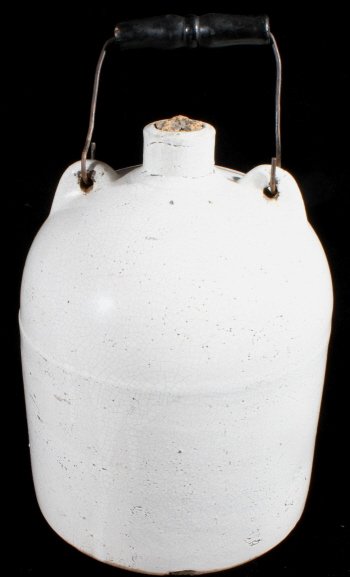 Vintage One Gallon Stoneware Jug With Wire Handle: This lot contain a very nice old primitive stoneware jug with handles and a wire bale with wooden dowel. This glazed stoneware jug is in very good condition for its age It has a fine web of antique cr