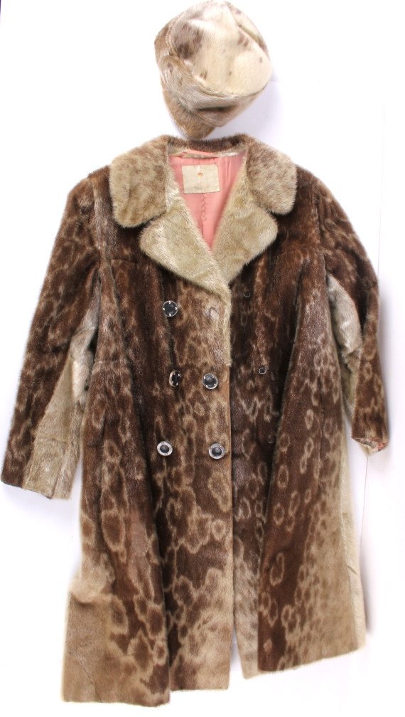 Magasin Du Nord Seal Skin Coat With Hat: This lot features a Magasin Du Nord seal skin coat with hat. The fur on the coat and hat is in good condition with only a small wear spot and display beautiful patterns. Magasin du Nord is a Danish ch