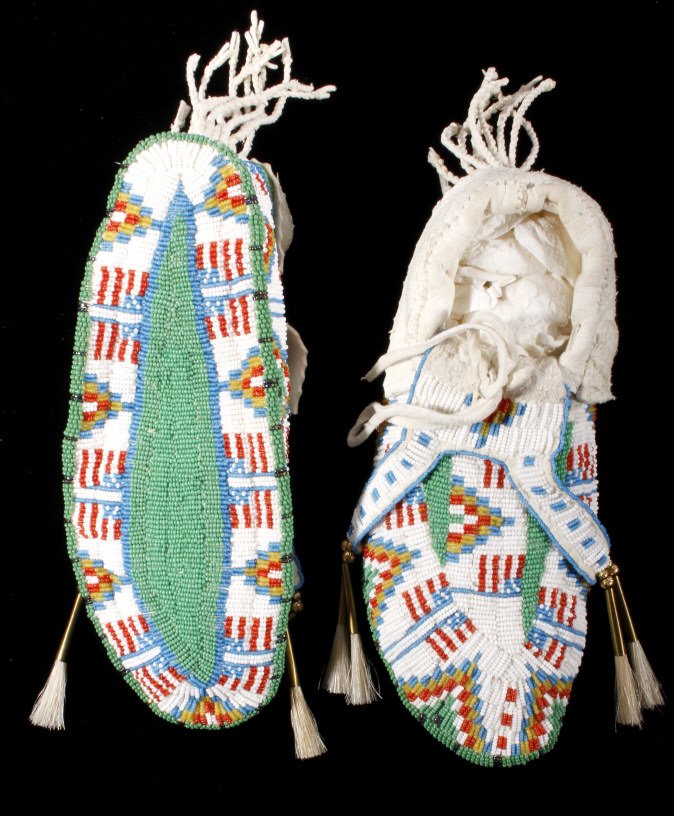 Oglala Sioux Fully Beaded Moccasins American Flag: This is a set of fully beaded Oglala Lakota Sioux moccasins with a unique patriotic US American Flag design. The 20th century moccasins are from the Pine Ridge Reservation in South Dakota. The pieces 