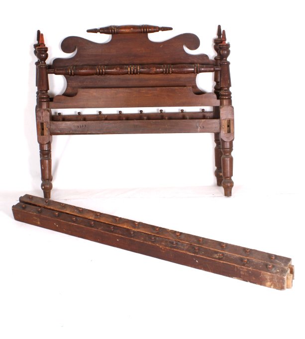 Antique Colonial Style Bed Frame: This lot features an antique colonial style bed frame. The bed frame is believed to be either oak or mahogany wood. Both the head as well as the footboard have spindle legs. The frame does come with r