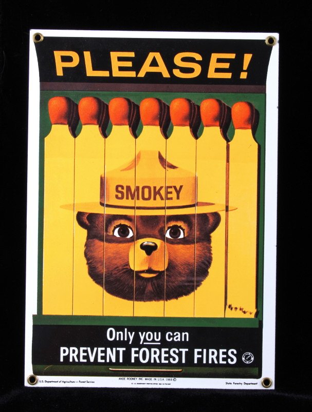 Smokey Bear U.S. Forest Service Porcelain Sign: This is a Smokey Bear porcelain enamel sign. Smokey Bear was adopted by the U.S. Forest Service back in the 1940's as part of their campaign to prevent forest fires. This sign shows a book of matches