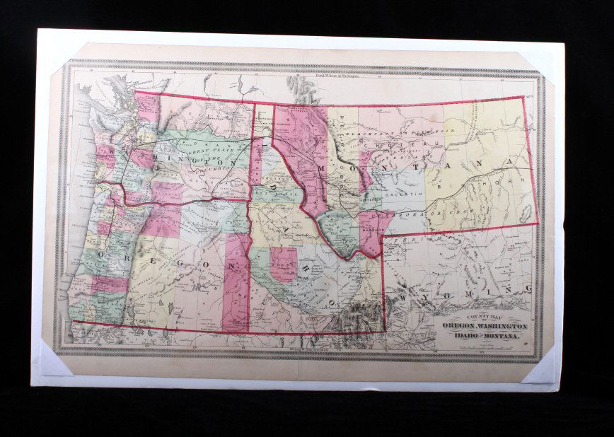 Hand Painted Map Of The North Western U. S.: This lot features a hand painted map of the north western United States. The hand painted map is out of a atlas. The paint highlights state and county lines in vibrant colors. The map itself is in goo