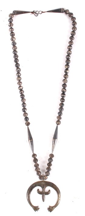 Sand Cast Old Pawn Navajo Silver Squash Blossom: This lot features a sand cast old pawn Navajo silver squash blossom. This early squash blossom was sand cast. It highly collectible Old pawn or dead pawn Navajo jewelry. The necklace has a striking de