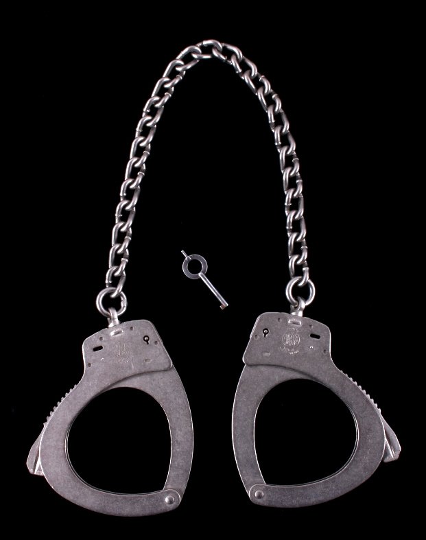 Smith & Wesson M1900 Leg Irons Handcuffs: This is a pair of Smith & Wesson M1900 leg irons. They are marked with the Smith & Wesson logo and "M1900". They are in good condition and come with a working key. These came from the private collecti