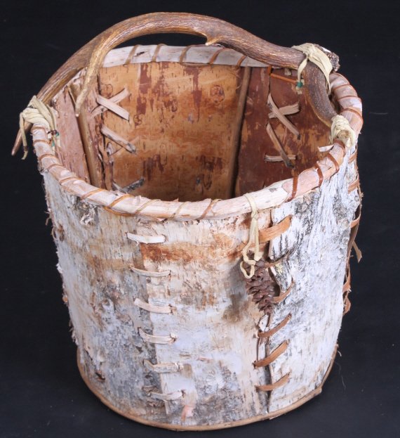 Primitive Deer Antler Basket: This lot features a primitive deer antler horn basket. The basket is reed stitched and displays beautiful birch bark panels. The basket was handmade with natural reeds roots and vines. The crown of th