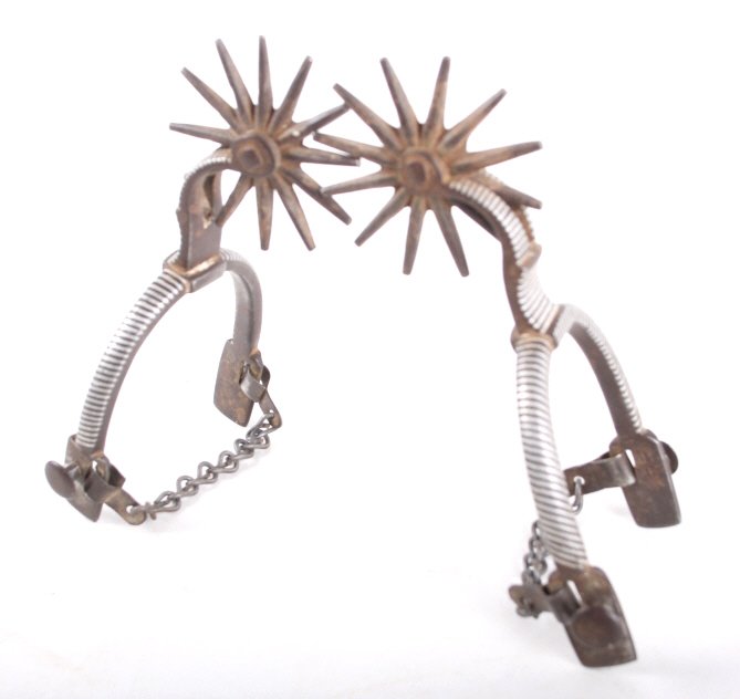 Baja Barber Pole Silver Mounted Spurs 19th C.: This lot features a rare set of barber pole style spurs from the mid to late 19th century. The spurs where made in Baja California. They are iron with double mounted inlaid silver in a barber pole str
